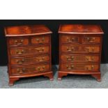 A pair of a George III style crossbanded mahogany bow fronted bachelor?s chests.(2)