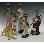 A resin figure, Lady Massai, 42cm; others similar; a model of a lion, 25cm wide (6)