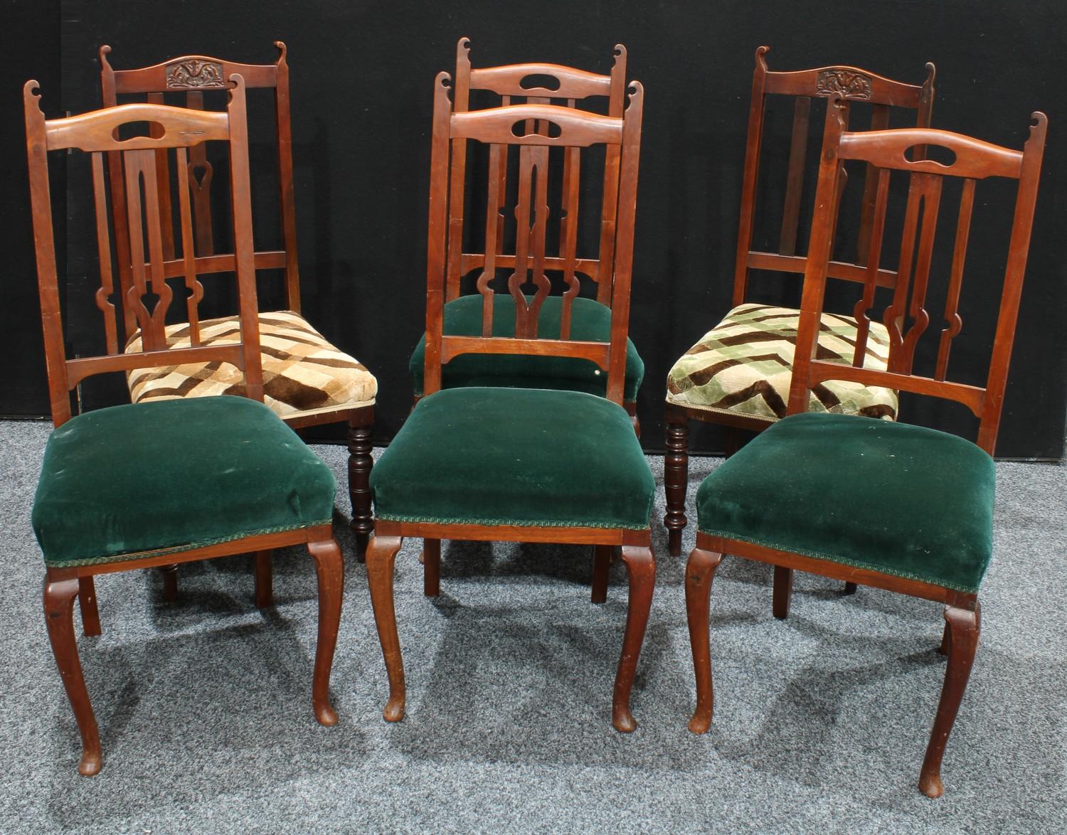 A set of four Arts and Crafts mahogany dining chairs, the backs pierced and shaped in the Art