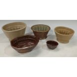 A 19th century brown salt glazed stoneware jelly mould, impressed with a partridge; others including