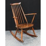 An Ercol rocking chair, elm saddle seat.