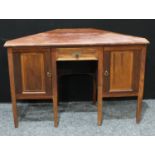 A 20th century mahogany desk, oversailing top above a short drawer flanked by a pair of cupboard