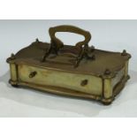 An early 20th century brass desk top box, sliding drawer, intertwined scroll handle, 28cm wide, 15cm