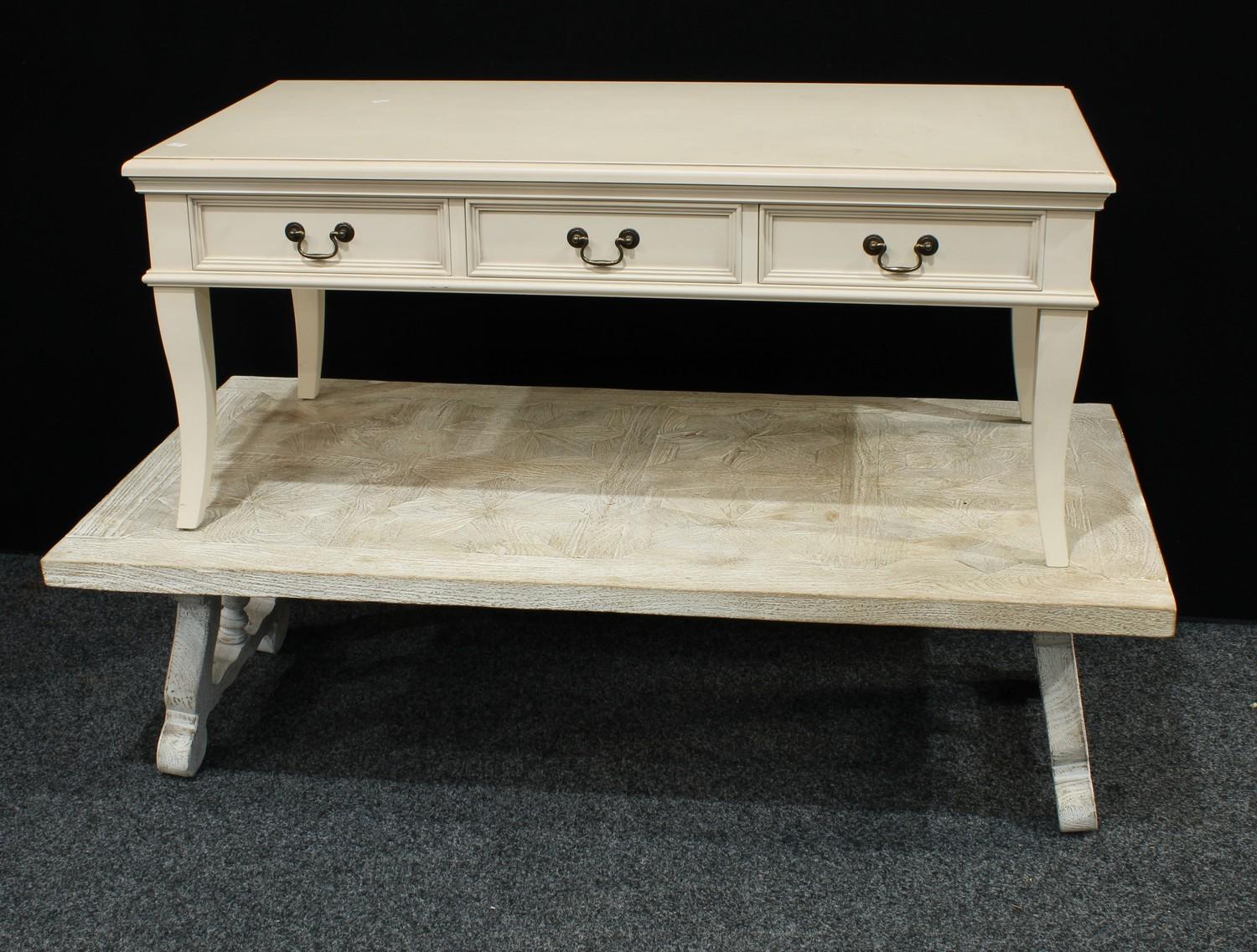 A contemporary painted white coffee table, rectangular top, lyre type end supports, 143cm wide, 77.