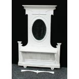 A 'Victorian' cast iron chimney piece, the painted superstructure with an oval mirror plate above