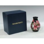 A contemporary Moorcroft inverted baluster vase, applied with roses and irises, 14cm, boxed