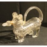 A late 19th/early 20th century novelty glass decanter in the form of a dog with stopper, 30cm long