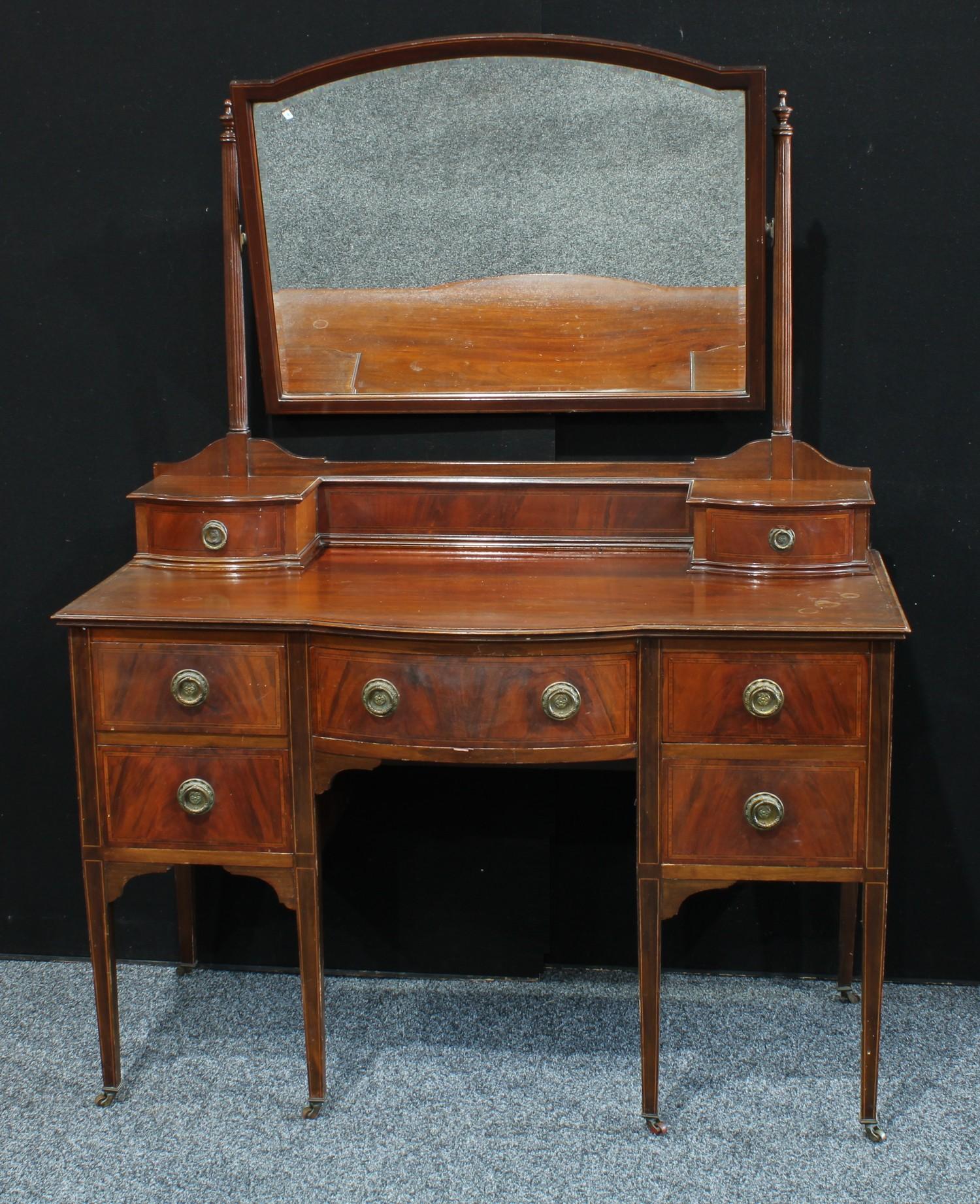 An Edwardian mahogany bow fronted dressing table, tapered square legs, 122cm wide