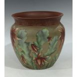 A late 19th century Langley Ware jardiniere, incised decoration in tones of pinks and green on a