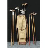 Sporting Interest - a mid 20th century canvas and leather golf bag containing 14 vintage clubsGolf