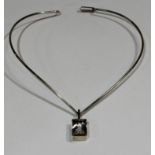 A Scandinavian, probably Danish, sterling silver choker necklace, suspended with a single clear