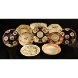 Two Spode circular plates, decorated with flowers in shaped reserves on a cobalt blue ground with