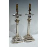 A pair of silver plated Corinthian column table candlesticks, converted for electricity, 34cm