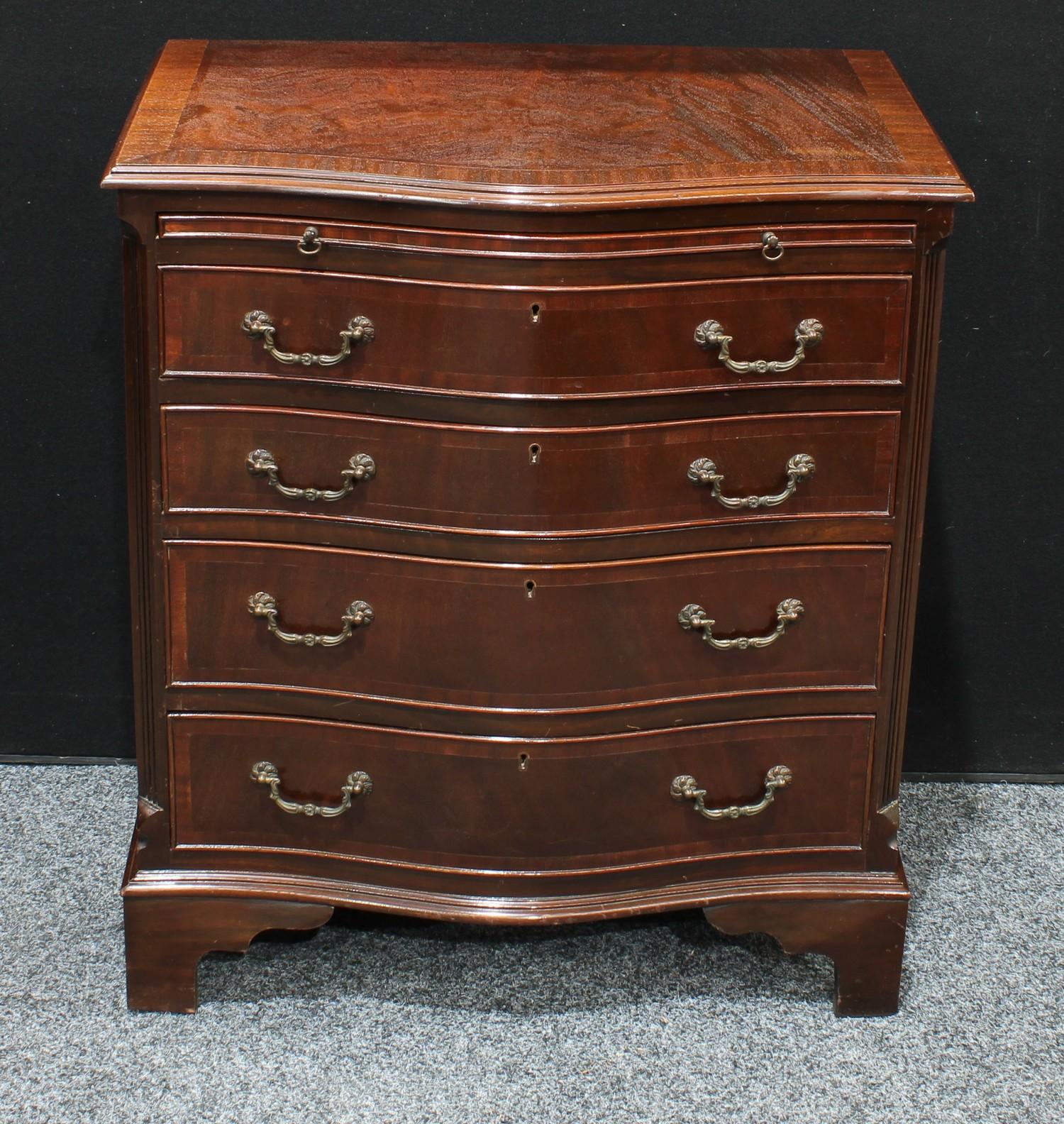 A George III style mahogany serpentine bachelor?s chest, the slide above four long drawers,