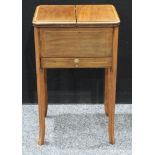 A 20th century mahogany sewing table, hinged top outlined with satin wood opens to reveal an