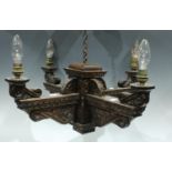 A carved oak Gothic style four branch ceiling light, with hanging attachments, fitted for