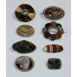 A multi panel agate inset eight petal floral brooch; a rounded rectangular moss agate panel