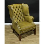A Chesterfield wing back arm chair, button back, scroll arms, H-stretcher, 108cm high.