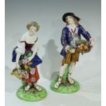 A pair Samson figures, of a gallant and companion, he with a basket of fruit, she with flowers, 23cm