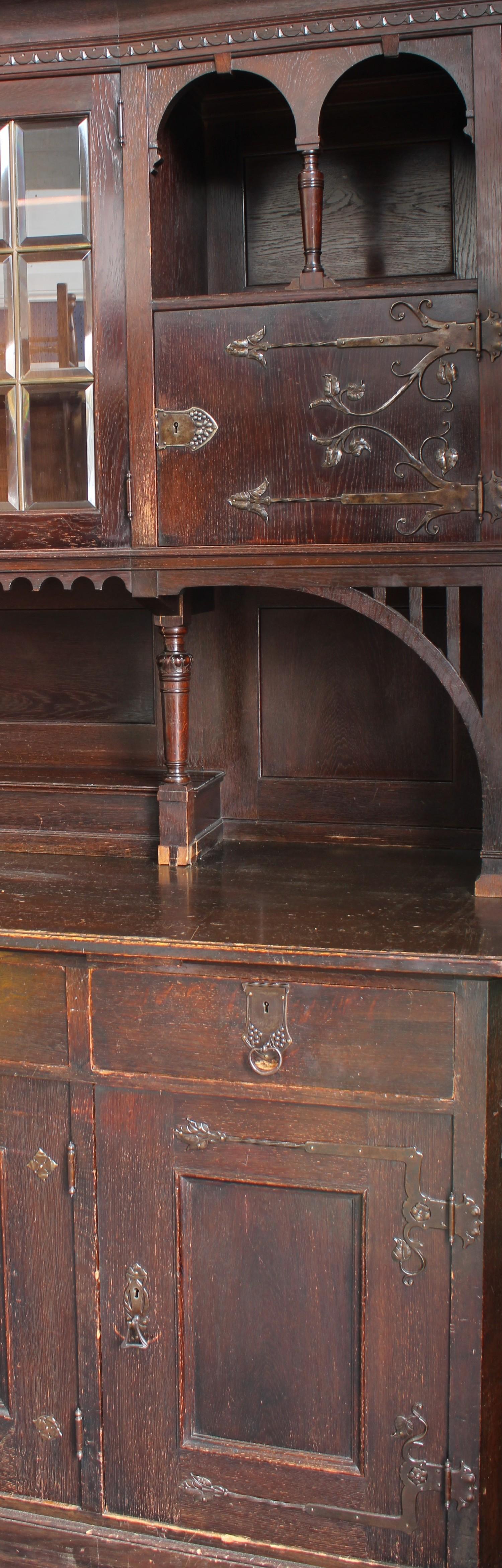 A substantial Arts & Crafts oak sideboard, outswept cornice above a pair of glazed doors enclosing - Bild 2 aus 2