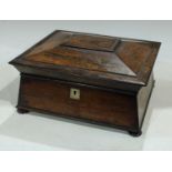 A post-Regency rosewood sarcophagus work box, hinged cover enclosing a lift-out tray, bun feet, c.