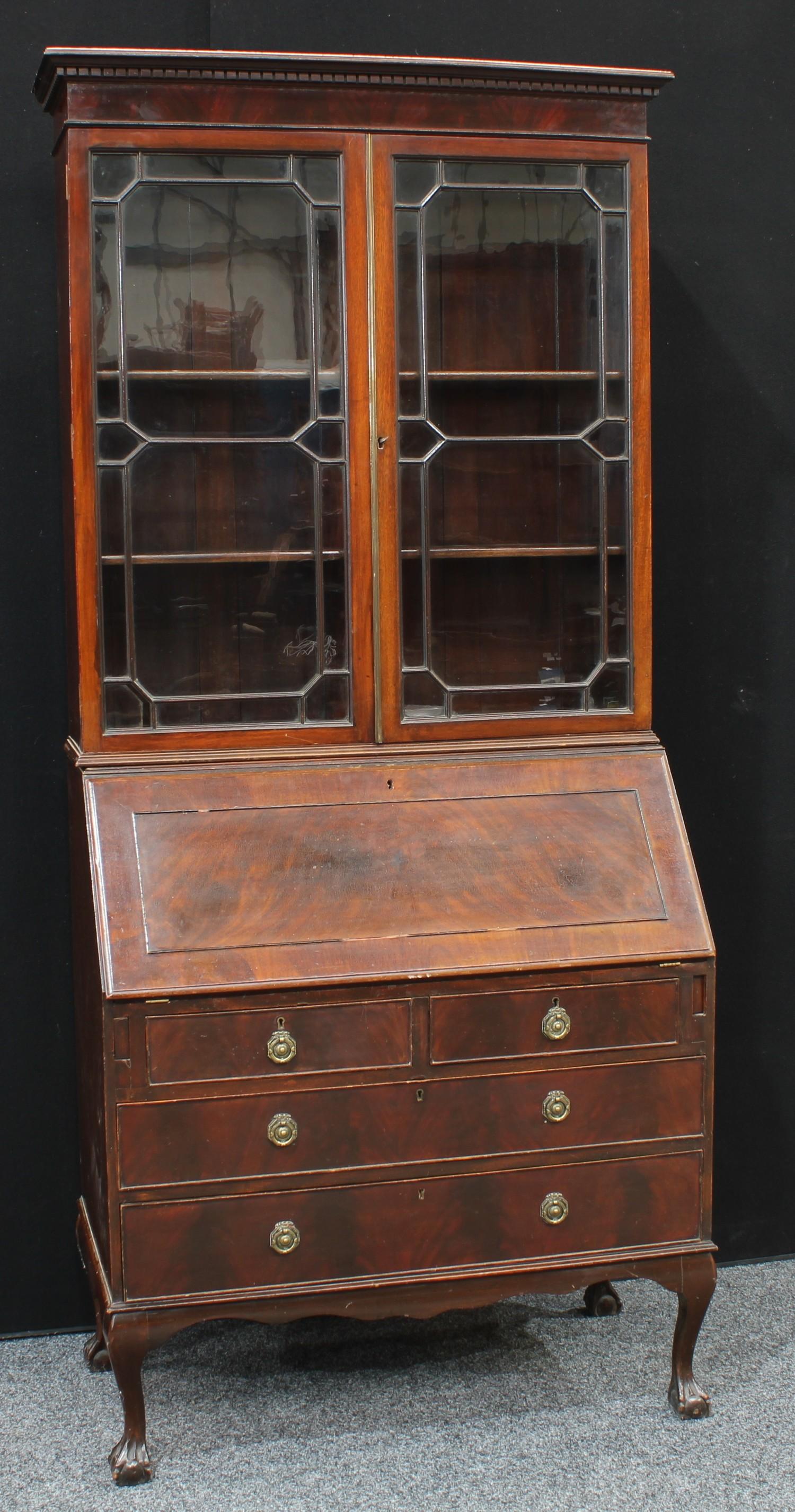 A 'Geroge III' mahogany bureau bookcase, dentail cornice above a pair of glazed doors enclosing