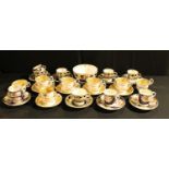Five Daniels coffee cups, teacups and saucers, pattern 4129, banded in salmon and applied in gilt