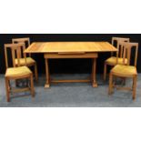 A 20th century art deco oak draw-leaf dining table; a set of four oak dining chairs.(5)