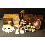 A wooden fold out sewing box, containing various late 19th century and later needle packets,