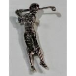 A silver novelty brooch, as a lady playing golf, 5cm long, marked Sterling
