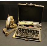 A mid 20th century Oliver portable typewriter; a clock movement (2)