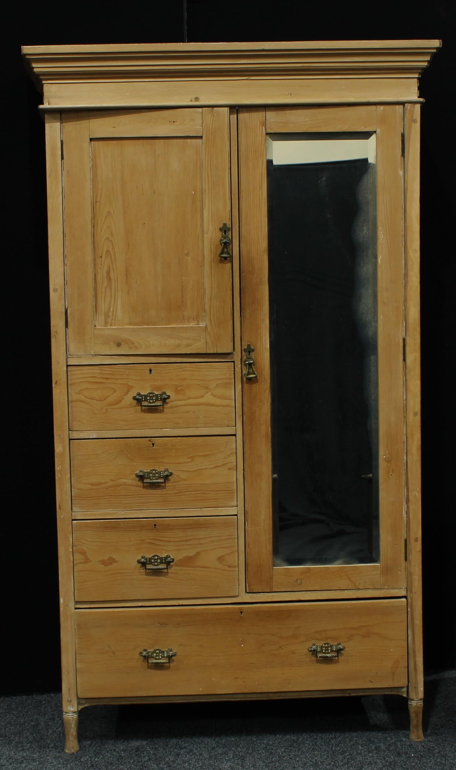 A country house pine wardrobe, outswept cornice, mirror door. 205.5cm high