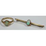 A 9ct gold opal bar brooch; an 18ct gold and opal ring