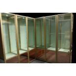 A suite of seven contemporary display cabinets, each configured to form a larger corner display