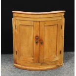 A 19th century pine bow front farmhouse kitchen wall hanging cabinet, 73.5cm high, approx 70cm wide