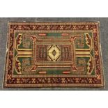 An antique Kazak rug, with geometric design of birds, flowers, and traditional motifs, triple