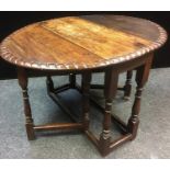 A George III oak drop leaf table, oval top with layer gadrooned border, turned and blocked legs.