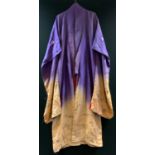 A hand painted and embroidered oriental robe, two tone fading purple to pink ground decorated to the