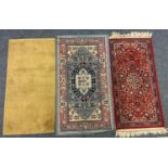 A Persian style rug, central floral diamond lozenge within multicoloured border, 145cm x 80cm;