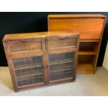 ; A mid 20th century mahogany side cabinet, with two fall fronts above glazed doors, 107cm wide, the