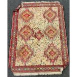An Antique Turkish Kilim rug, central panel of geometric medallions within multi coloured ground