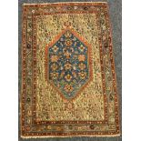 An Antique Persian rug, central geometric floral lozenge with blue ground, within cream