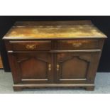 A Victorian oak sideboard, two drawers above two arched panel doors, undulating frieze, bracket