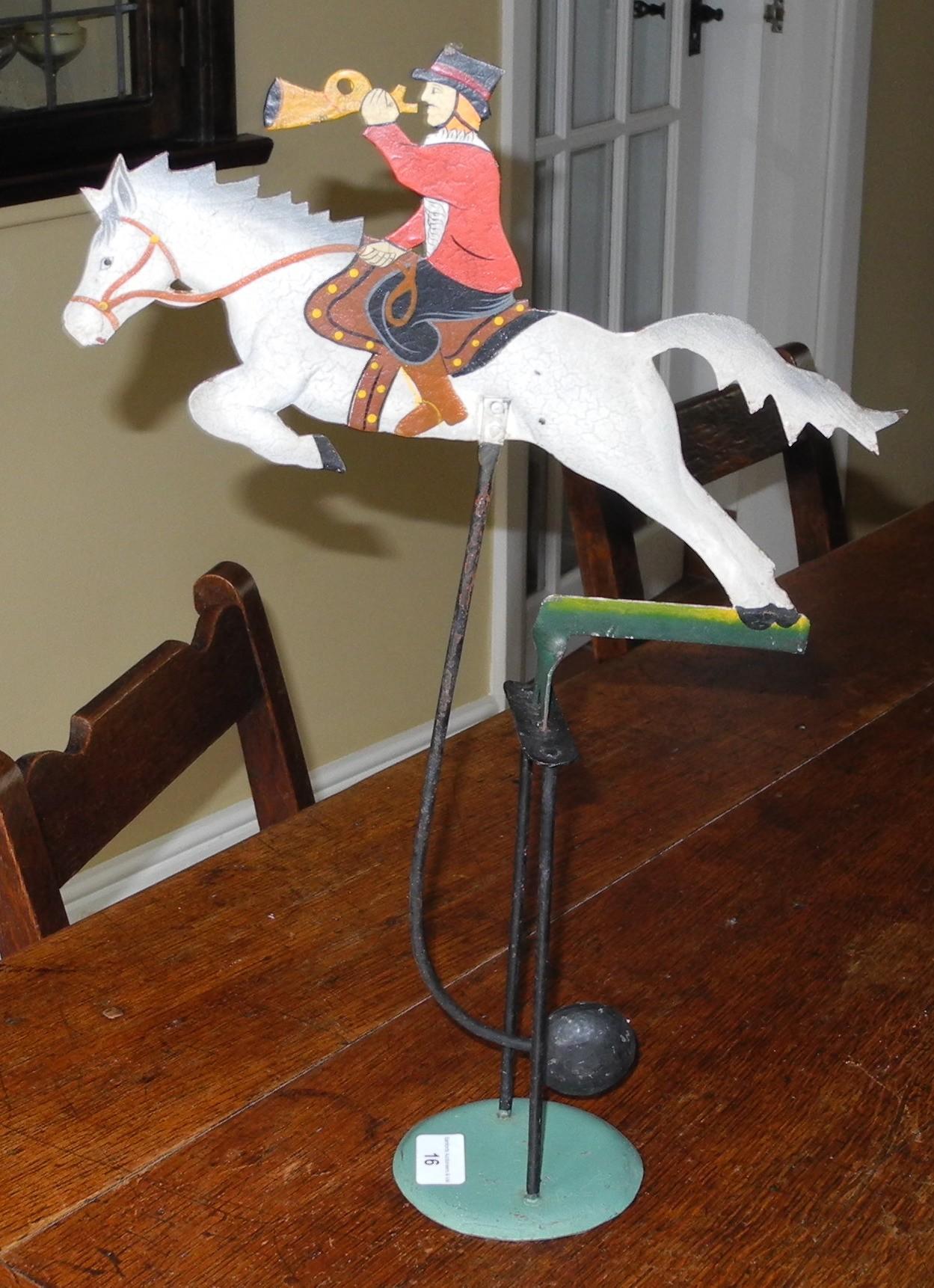 A contemporary tin automaton, in polychrome, of a huntsman on a grey horse, 47cm high