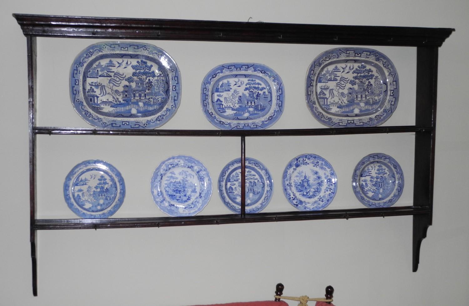 An 18th century oak open plate rack, with moulded cornice, two shelves and hooks, 11cm high, 180cm