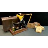 A vintage Singer hand operated sewing machine, cased; a 1960's Decca portable radio, angle poise