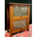 A mahogany book case with glazed up and over doors; 24 volumes of Encyclopedia Brittania, 82cm high,