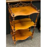 A Victorian three tier mahogany whatnot, pierced and shaped three quarter gallery, serpentine tiers,
