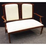 A late Victorian mahogany salon sofa, padded back and seat, tapering square forelegs