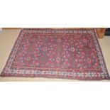A Middle Eastern woollen rug, with geometrical motifs, 162cm x 110cm